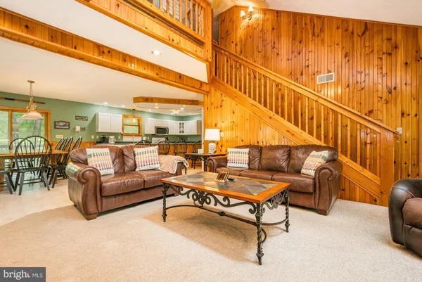 a kitchen with stainless steel appliances kitchen island granite countertop a stove a sink and a refrigerator