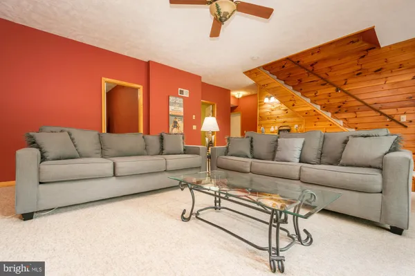 a view of a couch with table and chairs