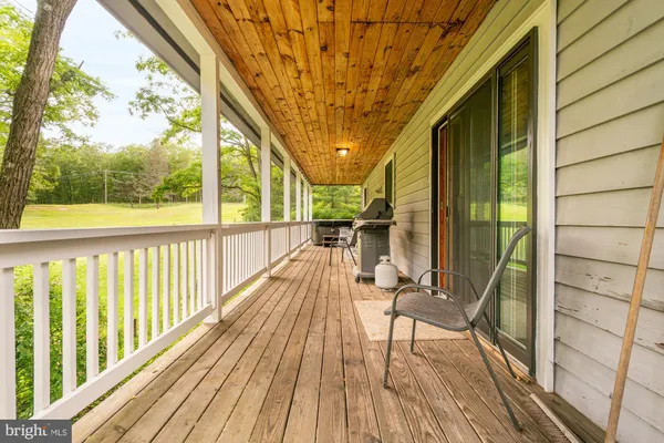 a view of balcony with wooden floor and fence