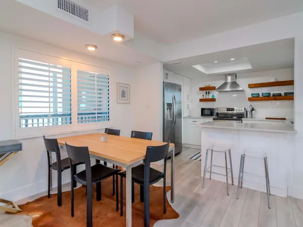 a kitchen with stainless steel appliances a refrigerator and a stove