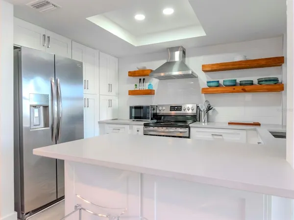 a kitchen with metallic refrigerator freezer and a dishwasher