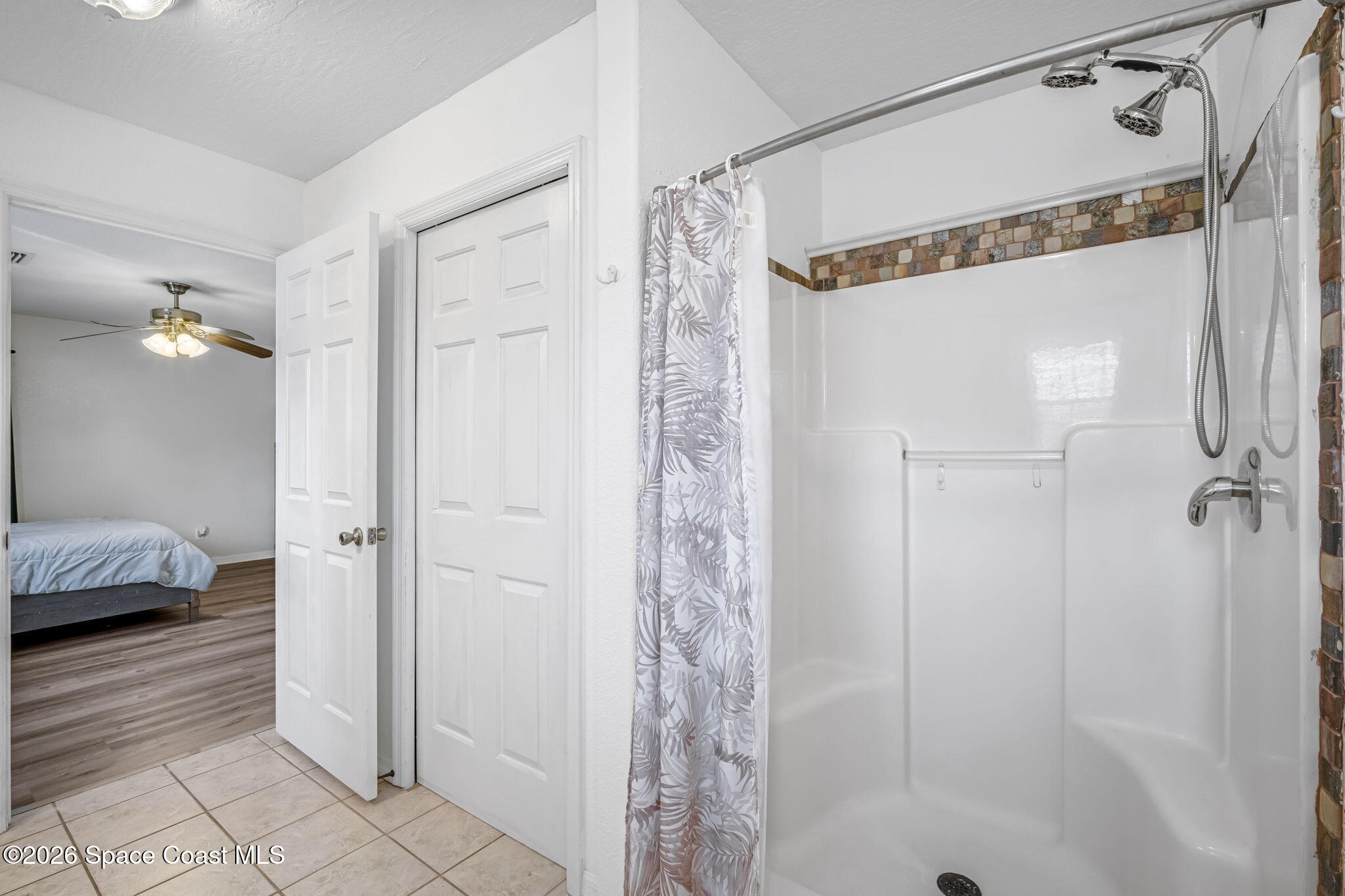 3404 Kilbee Street Mims, FL 32754 - Photo 18 of 30 a bathroom with a shower and a glass door shower