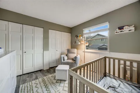 a view of a hallway with wooden floor and entryway