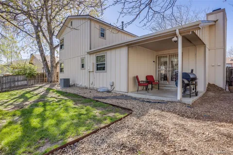 a view of a house with backyard and sitting area