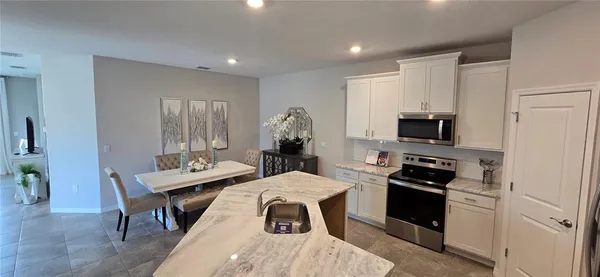 a very nice looking open dining room with a flat screen tv