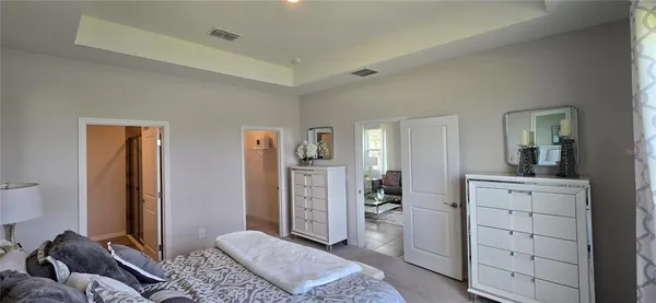 a bedroom with a bed and a dresser in it