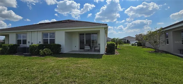 a view of a house with backyard and porch