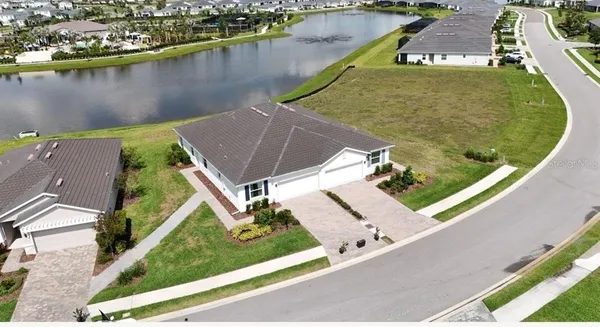 an aerial view of a house with a lake view