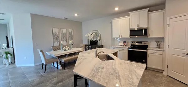 a kitchen with a stove a sink and a refrigerator
