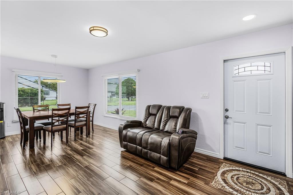 34 Hamlin Court Lehigh Acres, FL 33936 - Photo 9 of 29 a living room with furniture and wooden floor