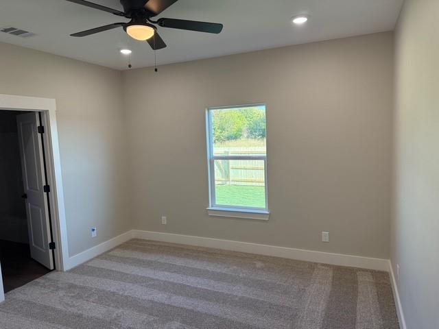 309 Garland Street Bells, TX 75414 - Photo 13 of 16 an empty room with a window and a fan
