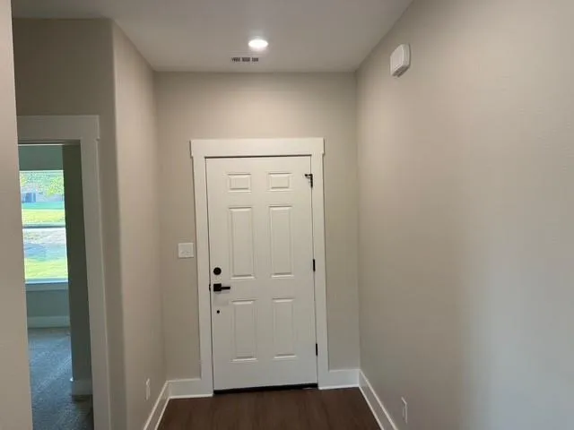 an empty room with wooden floor