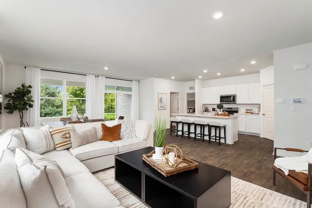 a kitchen with stainless steel appliances a sink stove refrigerator and cabinets