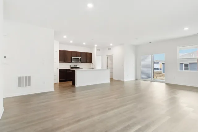 a kitchen with stainless steel appliances a microwave sink refrigerator and cabinets