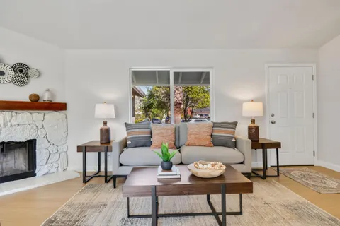 a living room with furniture and a fireplace