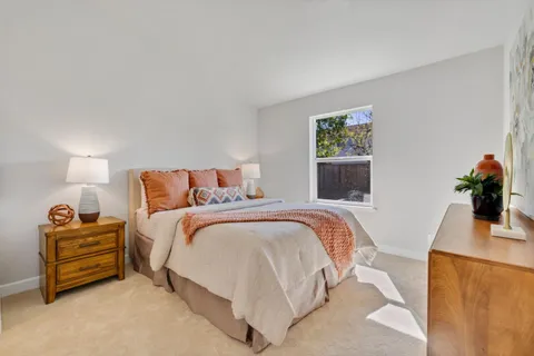 a bedroom with a bed and a couch