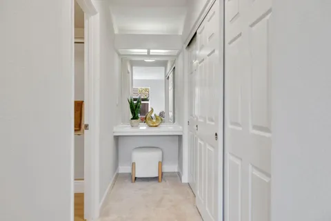 a view of room with wooden floor and mirror