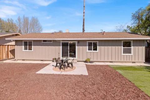 a front view of a house with a garden and patio