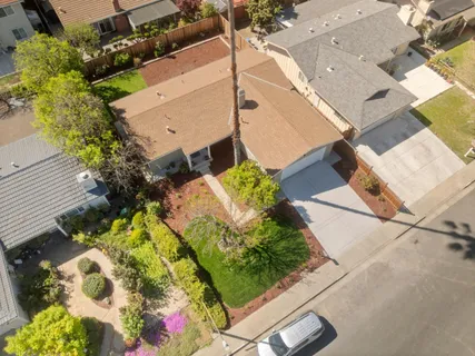 an aerial view of a house with a yard and garden