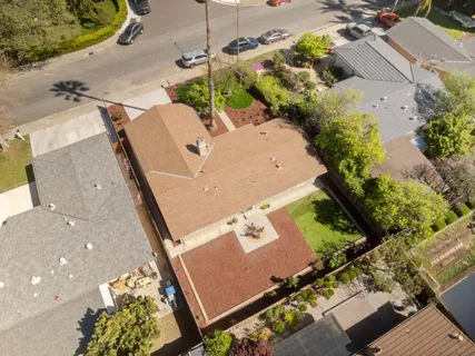 an aerial view of a house with a yard and trees