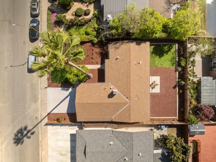 an aerial view of a house with a yard and garden