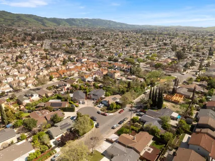 an aerial view of residential houses with outdoor space