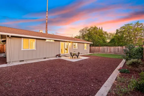 a view of an house with backyard space and garden