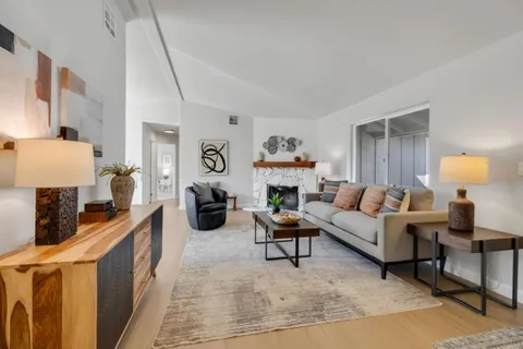 a living room with furniture and a lamp