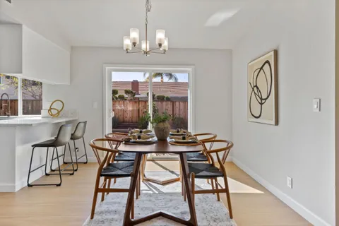 a view of a dining room with furniture window and outside view