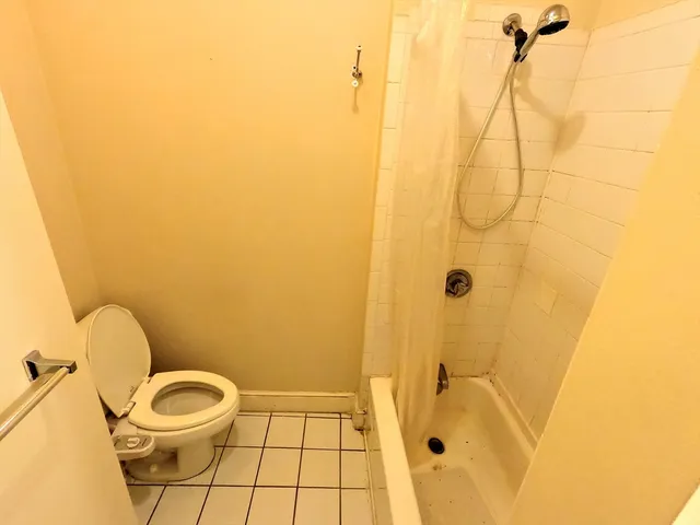 a bathroom with a toilet and shower