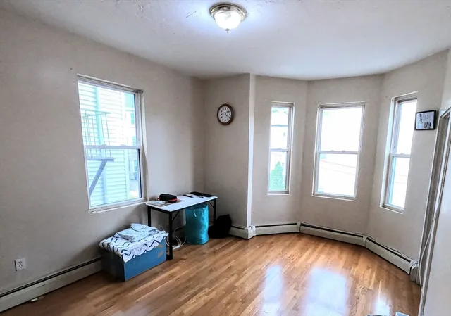 a view of a room with lounge chair and windows