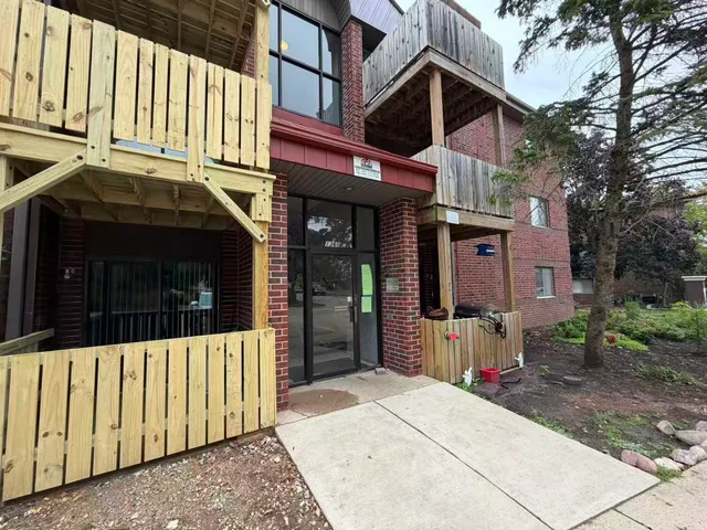 a view of a brick house with large windows
