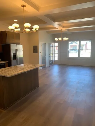 a kitchen with stainless steel appliances granite countertop a sink stove and cabinets