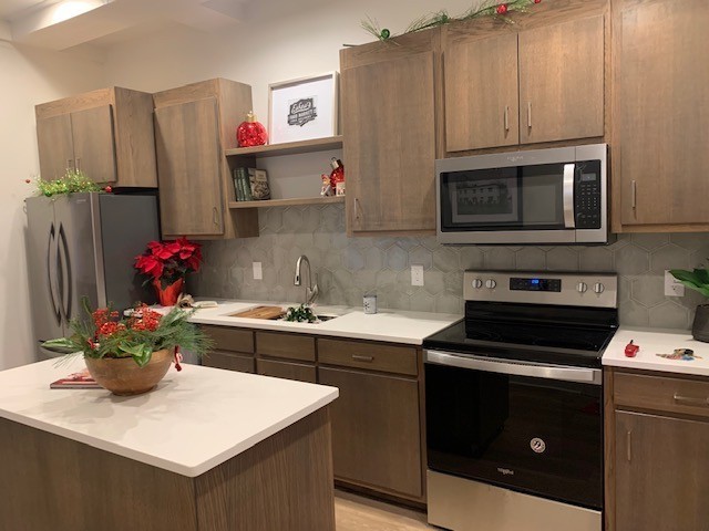 326 West Main Street Lebanon, TN 37087 - Photo 18 of 63 a kitchen with stainless steel appliances granite countertop a sink stove and cabinets