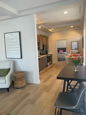 a kitchen with granite countertop a sink a counter top space stainless steel appliances and cabinets