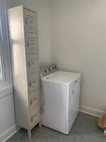 a living room with furniture and a lamp