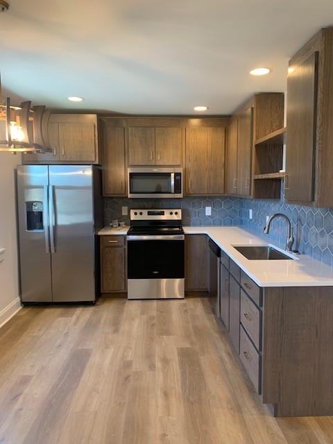 326 West Main Street Lebanon, TN 37087 - Photo 32 of 63 a kitchen with granite countertop a sink a counter top space stainless steel appliances and cabinets