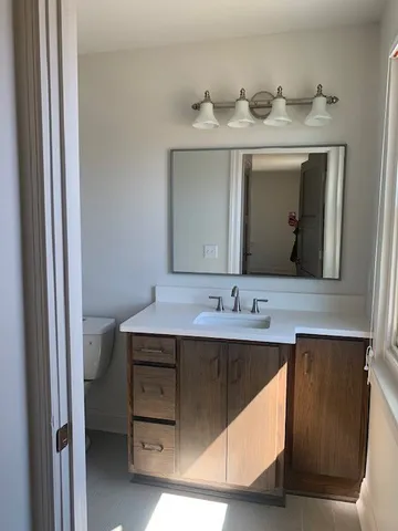 a bedroom with a bed and a lamp