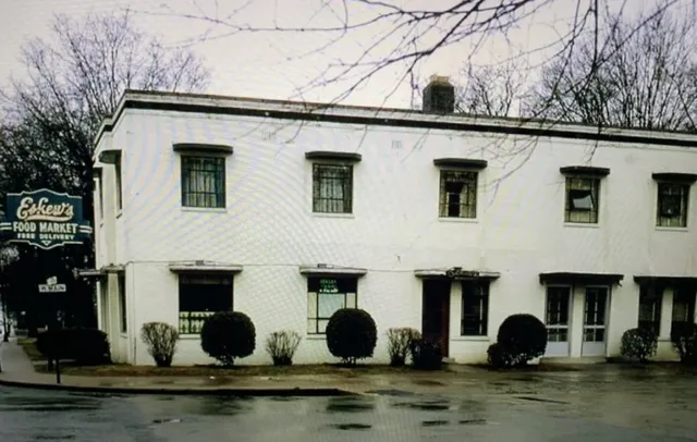 a room with kitchen island a chandelier stainless steel appliances and wooden floor