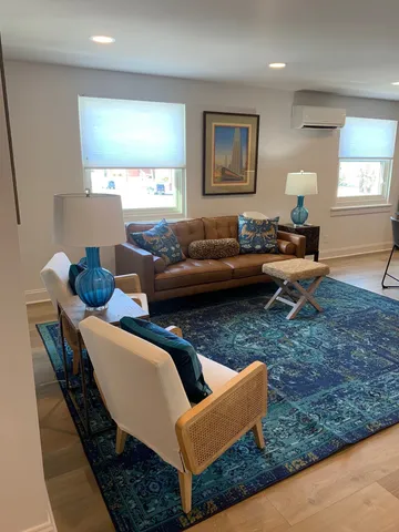 a large kitchen with cabinets wooden floor and stainless steel appliances