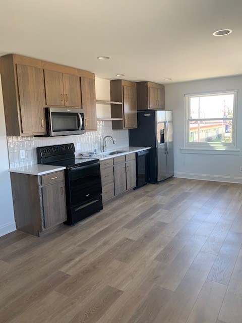 326 West Main Street Lebanon, TN 37087 - Photo 57 of 63 a large kitchen with cabinets wooden floor and stainless steel appliances