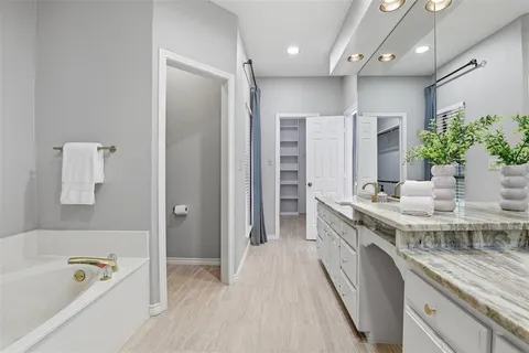 a kitchen with stainless steel appliances granite countertop a sink and a refrigerator