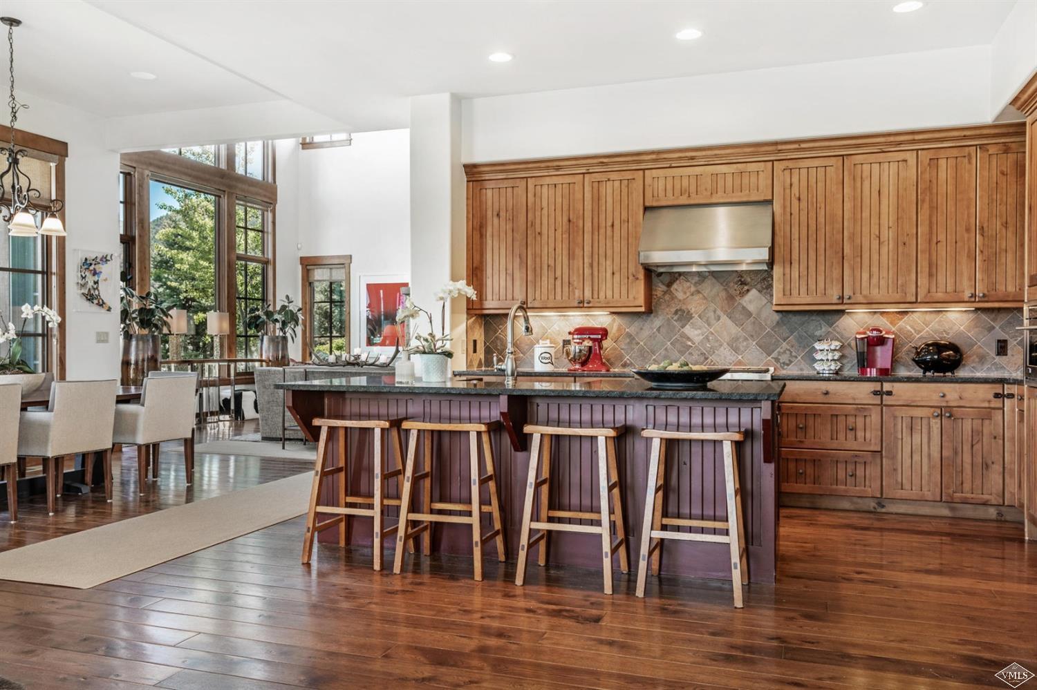 74 Lasso Gypsum, CO 81637 - Photo 6 of 25 a kitchen with granite countertop a table chairs stove and wooden floor