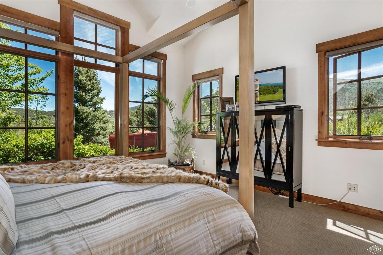 74 Lasso Gypsum, CO 81637 - Photo 9 of 25 a bedroom with a bed and large windows