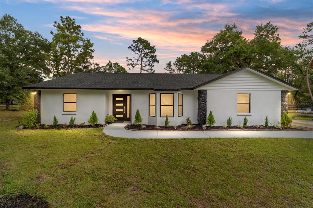 a view of a house with a yard and garage