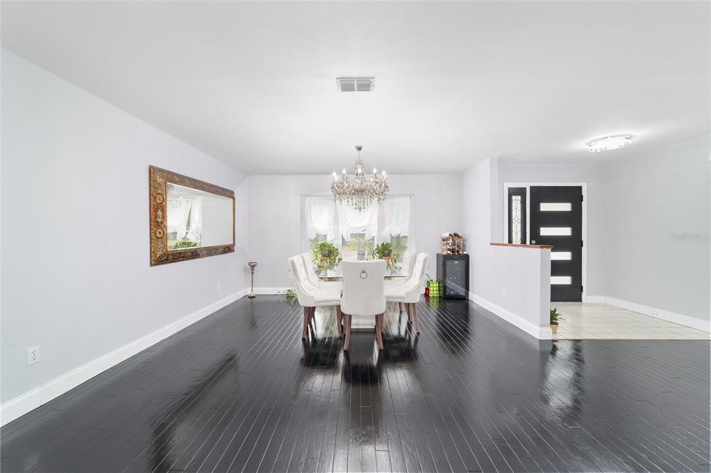 985 Northwest 73rd Terrace Ocala, FL 34482 - Photo 21 of 89 a view of a dining room with furniture and wooden floor