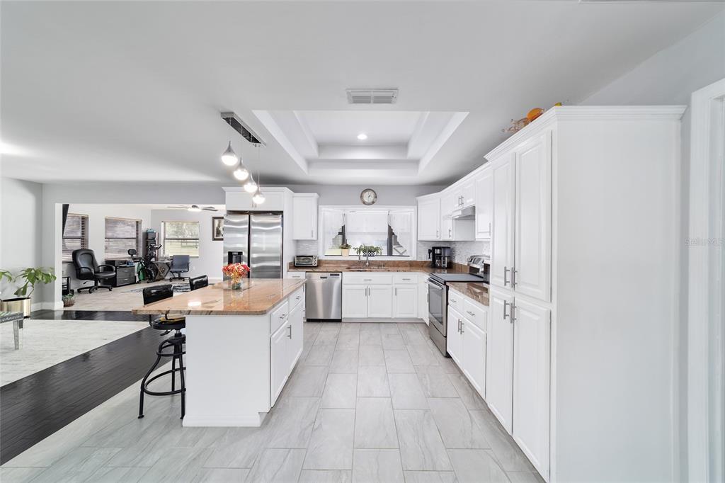 985 Northwest 73rd Terrace Ocala, FL 34482 - Photo 22 of 89 a kitchen with white cabinets and white appliances