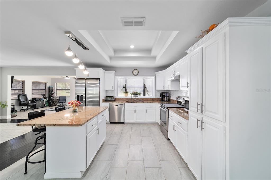 985 Northwest 73rd Terrace Ocala, FL 34482 - Photo 26 of 89 a kitchen with counter top space a sink cabinets and stainless steel appliances
