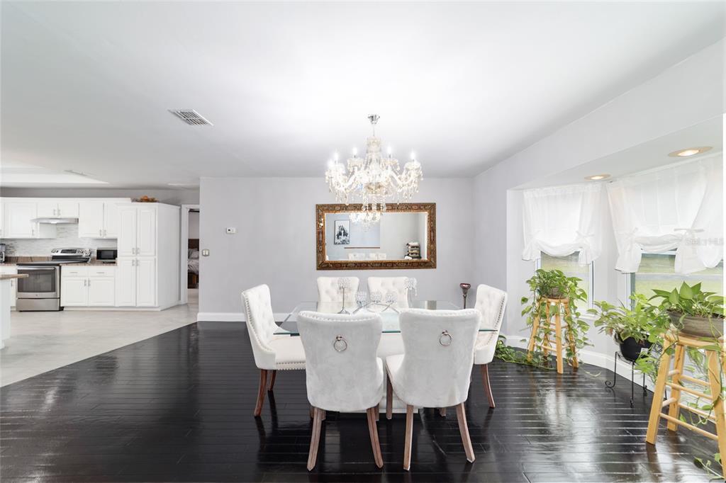 985 Northwest 73rd Terrace Ocala, FL 34482 - Photo 31 of 89 a view of a dining room with furniture and wooden floor