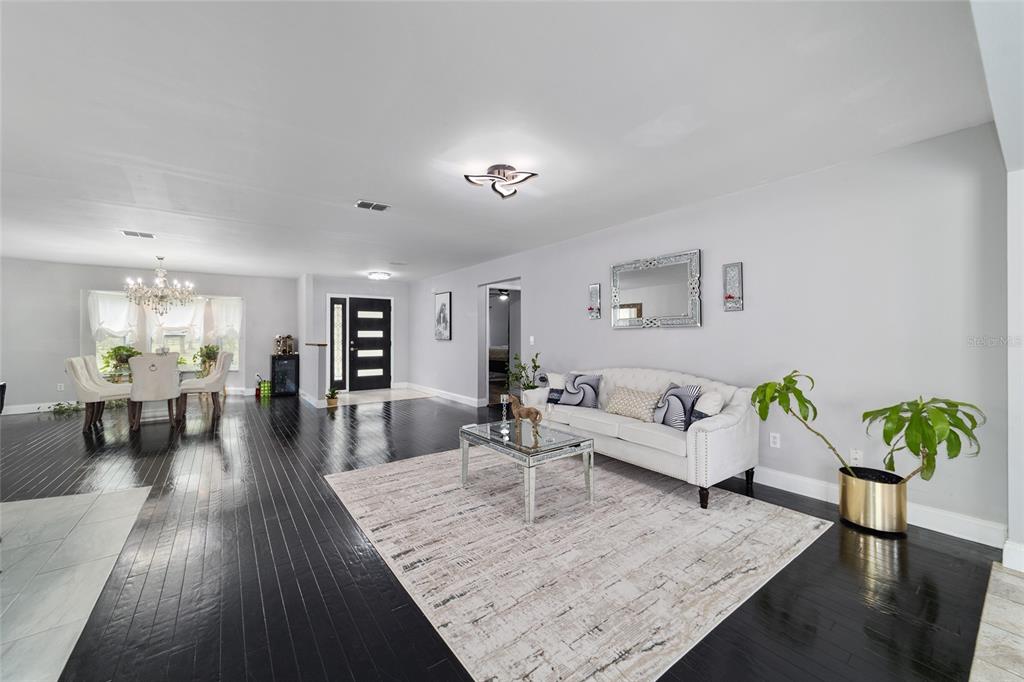 985 Northwest 73rd Terrace Ocala, FL 34482 - Photo 37 of 89 a living room with furniture and a wooden floor